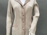 an image of a mannequin wearing a beige jacket and black pants