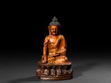 an image of a wooden statue of a person sitting on a rock