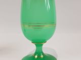 two green vases sitting next to each other on a table