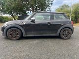 a picture of a black mini cooper parked in a parking lot