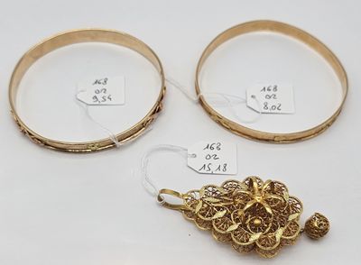 three gold bracelets and a gold broochet broochet broochet broochet broochet broochet broochet broochet bro