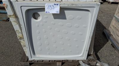 un réfrigérateur blanc posé sur une palette, avec une étiquette de prix dessus