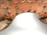 a close up of a wooden object on a white surface