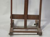 a small wooden table with a glass top on wheels