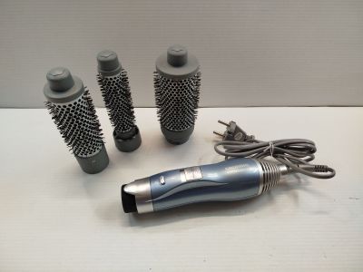 three different types of hair brushes and a blow dryer on a table