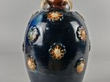 un vase bleu orné d'étoiles dorées, posé sur une table