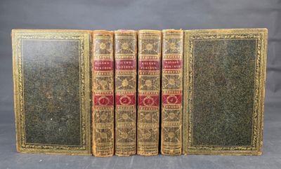 three old books sitting on top of each other on a table