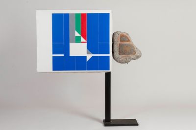 a sculpture of a rock on a stand with a flag on it