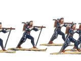 four figurines of a woman with skis and poles on a white background