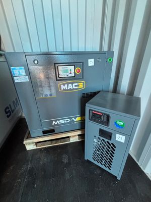 two air compressors sitting next to each other on a pallet