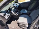 the interior of a car with a steering wheel and a seat in it