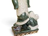 a statue of a dog that is sitting on a table