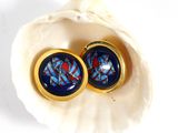 a pair of earrings that are sitting in a shell