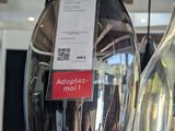 two vases that are on a table with a price tag