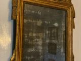 a mirror hanging on the wall with a clock on it