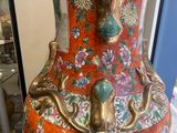 a large vase that is on display in a glass case