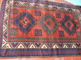 rug on the ground with a blue and red design on it