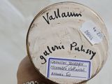 a person holding a jar with a label on it