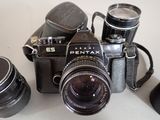 three cameras sitting on a table next to each other