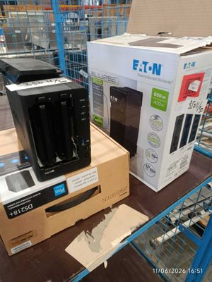 boxes of electronic equipment sit on a shelf in a store