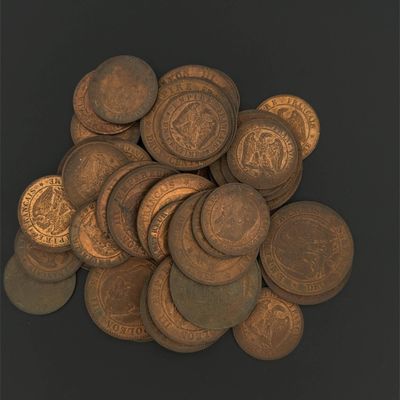 a pile of coins sitting on top of a black surface