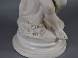 a statue of a woman sitting on top of a pedestal