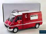 a red toy ambulance truck with a box in the background