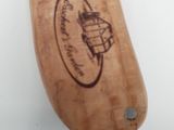 a wooden knife with a picture of a bee on it