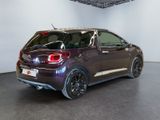 a picture of a purple car in a showroom