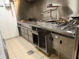 a kitchen with a lot of stainless steel counter tops
