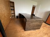 a wooden desk in the middle of a room