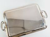 silver plated serving tray with handles and handles on a white surface