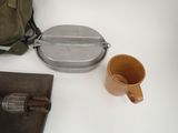 a bag, a cup, and a book on a table