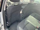a black seat in the back of a car with the door open