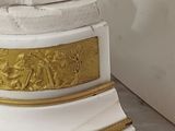 a statue of a lion on top of a white pedestal