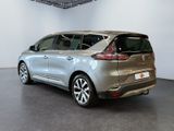 the rear end of a silver car in a showroom