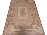beige area rug with a floral design on a white background
