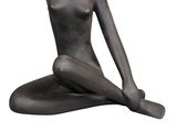 statue of a woman sitting on her knees on a white background