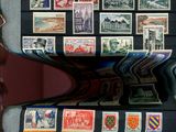many different stamps on the black paper on the table