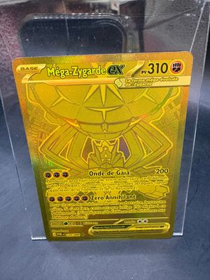 yellow pokemon card in a clear plastic box on a table