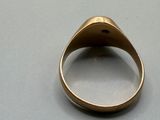 an image of a gold ring on a table