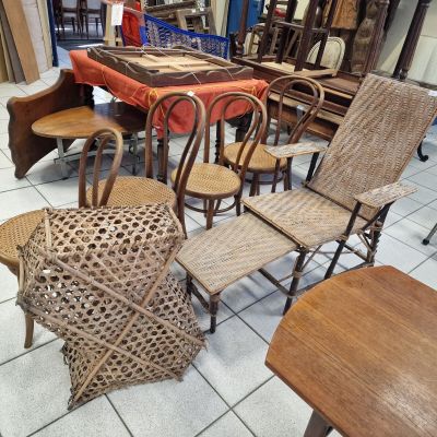 several chairs and tables in a room with a table and chairs in the background