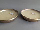 pair of gold metal bowls with lids on a gray surface