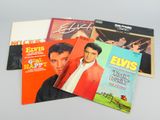 three elvis presley album covers on a white surface
