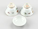two chinese bowls and a bowl with a saucer on a table