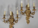 pair of antique brass wall sconces with white candles