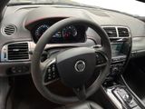 the interior of a car with a steering wheel and dashboard controls