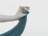 a statue of a woman holding a fish in her hand