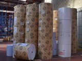 many rolls of paper sitting in a warehouse area