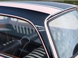 a pink and black car parked in a parking lot